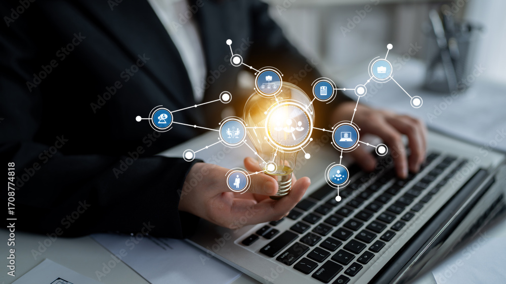 Poster a business professional engaged in data analysis using a laptop, surrounded by digital interface ico