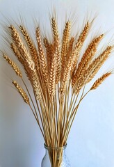 Fototapeta premium Wheat Stalks Arranged in a Decorative Bouquet for Home Decor and Agricultural Themes.
