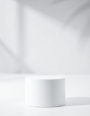 Pure white cylindrical podium on white background. Empty pedestal. Minimalist product mock-up