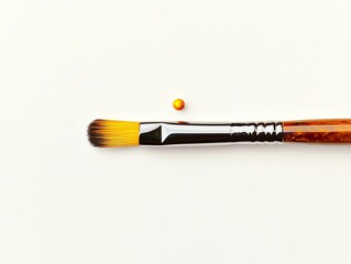 Fototapeta premium Paintbrush and paint drop on white background, symbolizing creativity and artistic expression.