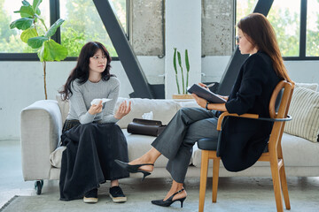 Sad stressed young woman patient talking with female psychologist, mental counselor