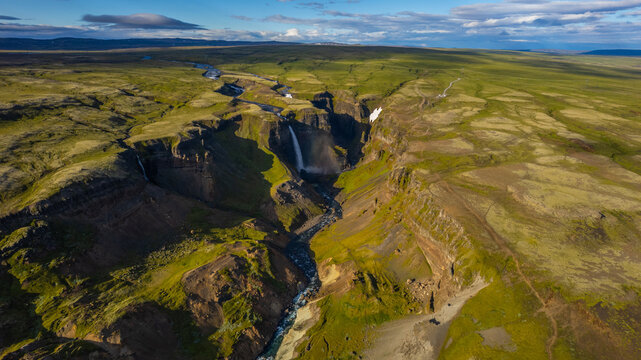 Iceland Haifoss and Granni twin waterfalls dropping into deep canyon with rugged green cliffs and river flowing through volcanic highlands