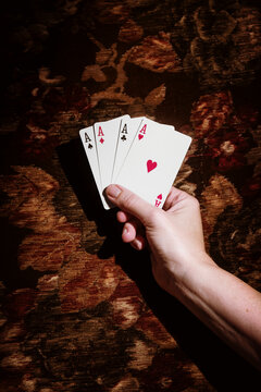 Winning Hand With Four Aces in a Card Game Setting