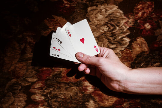 Winning Hand With Four Aces in a Card Game Setting