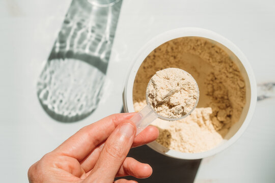 Woman Measuring Protein Powder