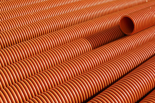 Curved Orange Drainage Pipes Arranged in a Neat Pattern Outdoors