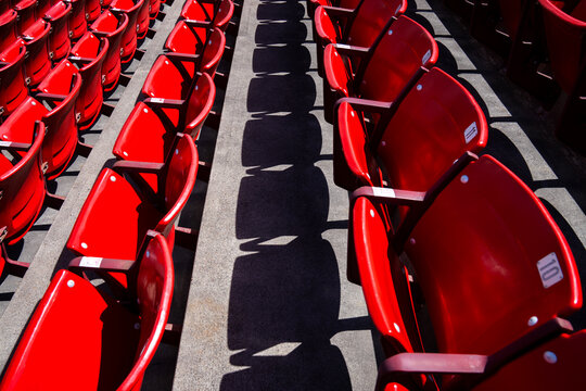 Stadium Seating Captured in Bright Red Colors During Midday