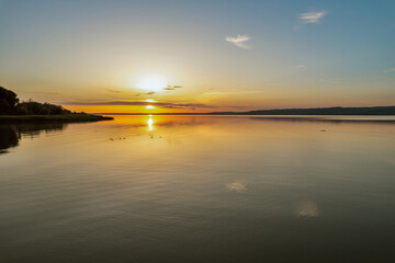 Fototapeta premium Spectacular sunset over lake Balaton with golden reflections, Hungary.