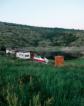 Scenic Lakeside Landscape With Wooden Cabins and Rustic Boating 