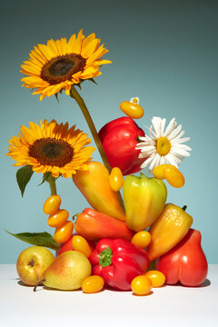 Still life with Fruits and Flowers on Gradient Blue Background.