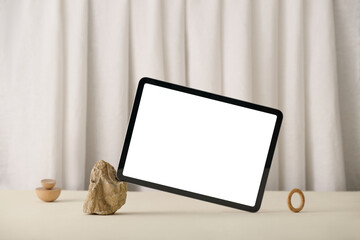 A modern tablet with a blank screen. minimalist wooden decor