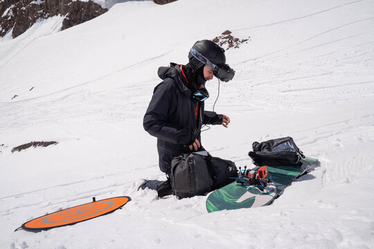 Drone pilot adjusting equipment in deep snow