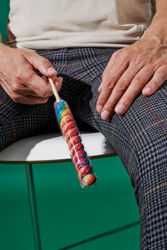 a man holding a spiral lollipop pointing downward