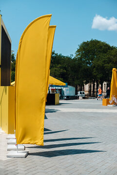 Yellow flags against the summer street.