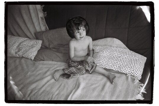 The Child Is Playing At Home On The Couch