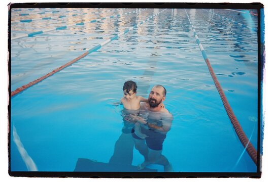 Toddler And His Father Spend Time In The Pool