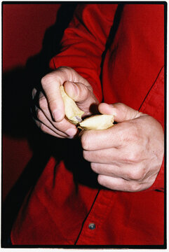 close-up of a man opening a fortune cookie with his fingers, 35mm