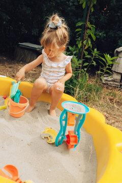 Toddler girl in sandbox 