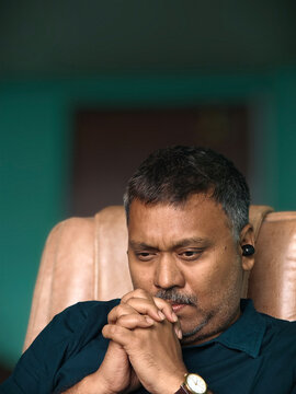 Middle aged man listening music and thinking deep