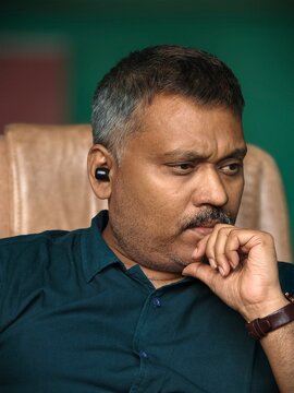 Middle aged man listening music and deep thinking