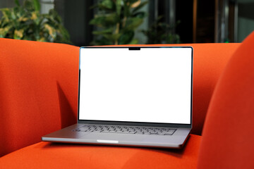 Laptop Mockup with white screen on Red Couch Seat