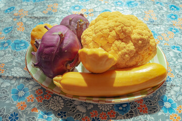 Colorful assortment of fresh vegetables on a plate in daylight