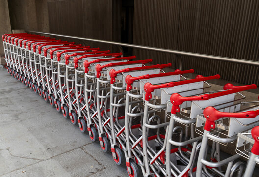 Baggage Carts Lined up Outside an Airport Terminal