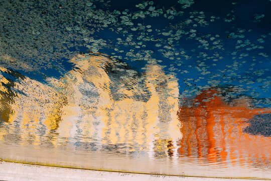 Reflection of historic buildings in calm water during sunset