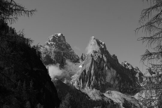Black and white Dolomites with fog and massive rocky peaks