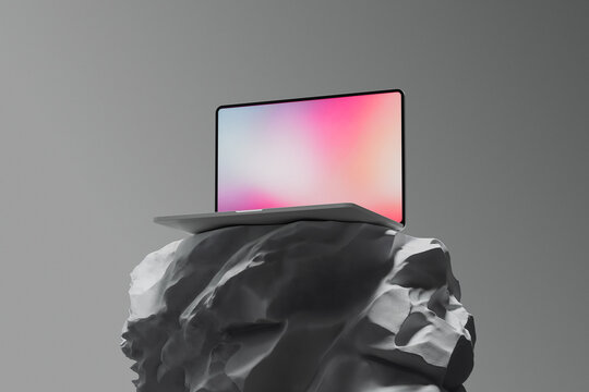Unique laptop balanced on a rock in a minimalist setting