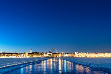 Blue hour from the ice track and the city lights reflecting and spreading warmth in the cold this winter dusk in Luleå, northern Sweden. A wonderful colour show for those who explore
