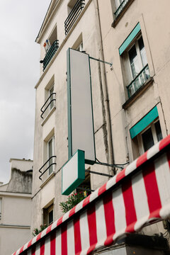 A skewed perspective of the facade of a rustic hotel in Paris