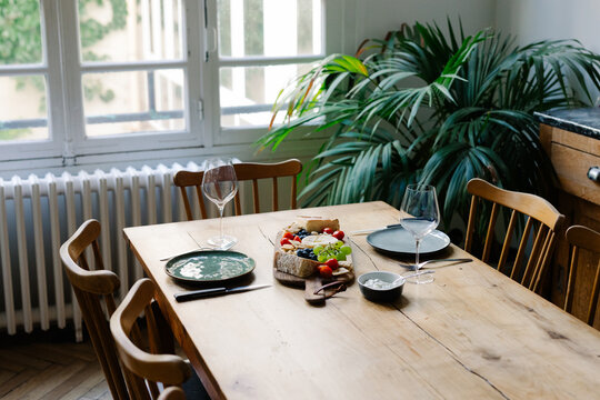 Dining table featuring fresh salmon, assorted French cheese and wine