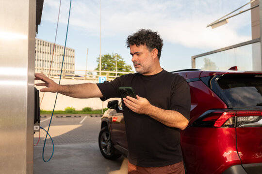 Man Ordering Cleaning Program at Self-Service Car Wash 