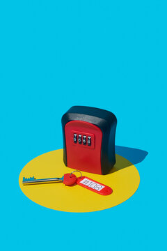 a red and black lockbox and a key from above
