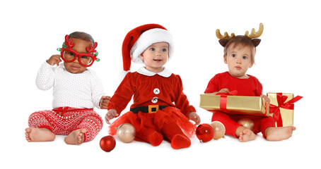 Cute babies in Christmas clothes on white background