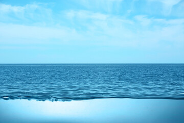 Fototapeta premium Sea water surface and underwater view. Sky with clouds above