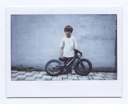 Todder With His Balance Bike On The Street