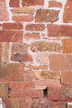 Fototapeta Close-up shot of a weathered brick wall, showing texture details 