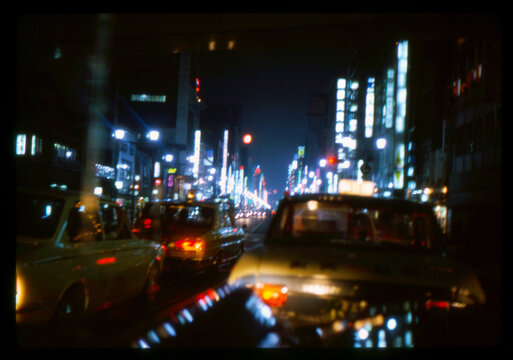 Vintage Film Photo of City Night Traffic with Neon Lights