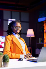Portrait of remote worker at home office desk browsing internet on notebook, researching information online. Young woman using search engines to find data for work tasks, reading articles