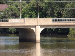 Fototapeta premium Concrete Bridge Spanning Over Tranquil River