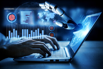 This image captures the interaction between a human hand and a robotic arm over a computer screen displaying advanced data visualization and analytics. Impute