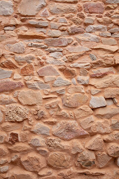 A textured stone wall man made with natural stone