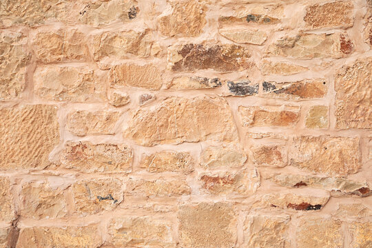 A textured stone wall man made with natural stone