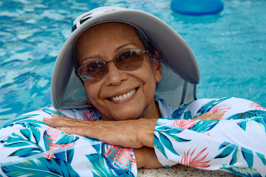 Elderly woman smiling in the pool