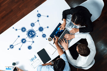 Overhead view of a diverse team engaged in a dynamic business meeting, using technology to analyze data, foster collaboration, and drive innovative ideas forward. Amity