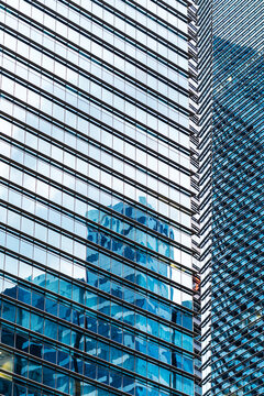 Corporate buildings merge in glass surface reflections 