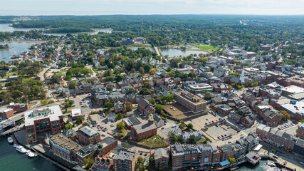 Aerial view of downtown Portsmouth, New Hampshire with historic brick buildings, waterfront, and clustered neighborhoods.