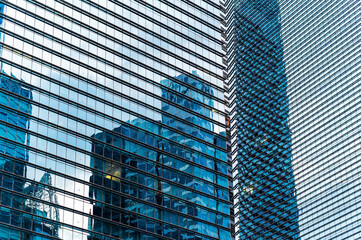 Urban development reflected in office building glass 
